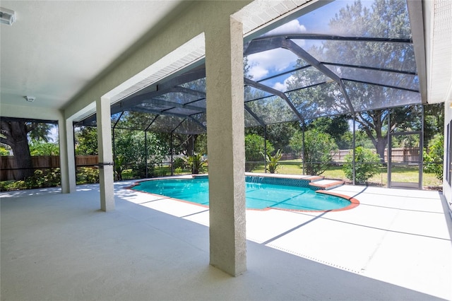 view of pool with a patio and glass enclosure