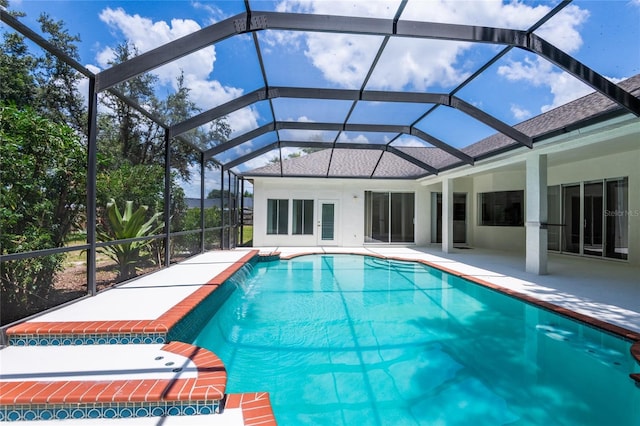 view of pool featuring pool water feature, a lanai, and a patio