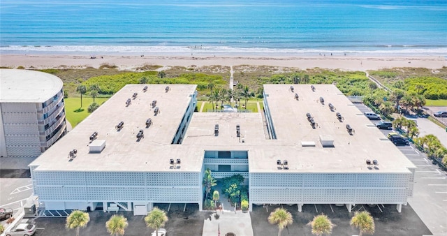 drone / aerial view with a beach view and a water view