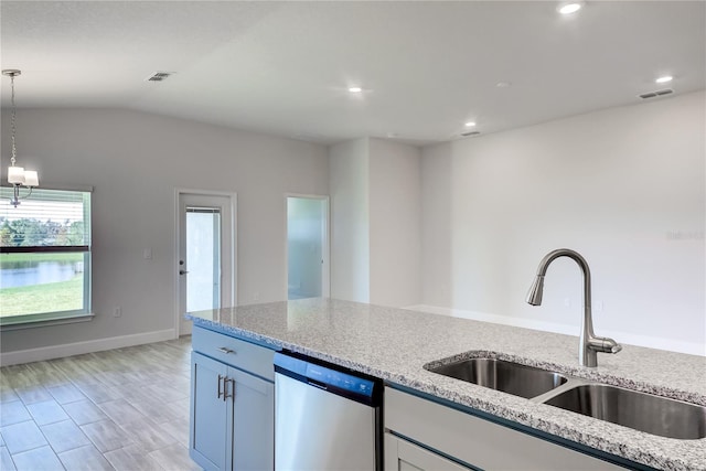 kitchen with stainless steel dishwasher, light stone countertops, sink, and hanging light fixtures