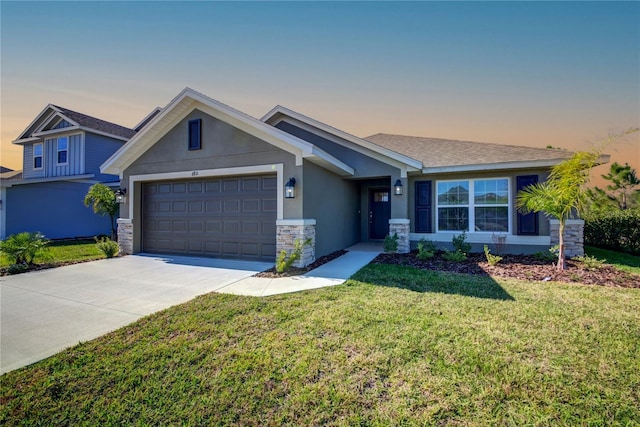 view of front of property featuring a lawn and a garage