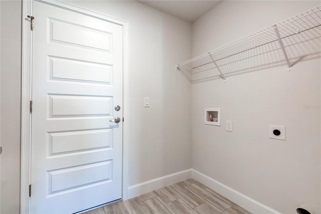 washroom with hookup for an electric dryer, washer hookup, and light hardwood / wood-style flooring