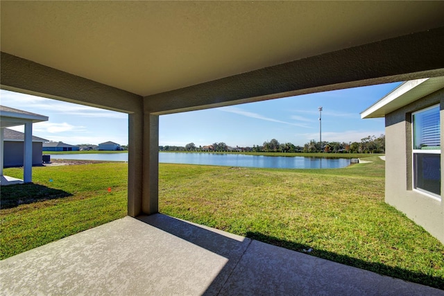 view of yard with a patio area and a water view