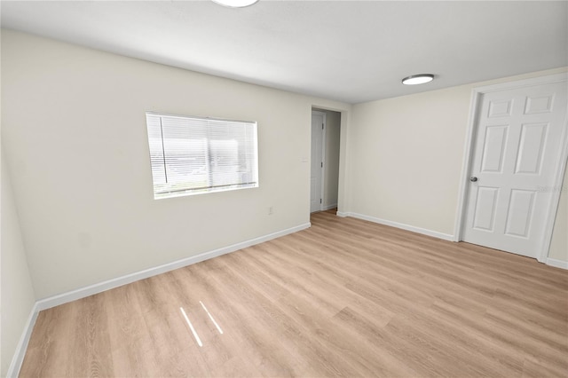 spare room featuring light wood-type flooring