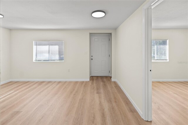 unfurnished room with light hardwood / wood-style flooring and plenty of natural light