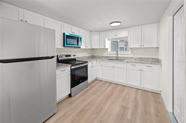 kitchen featuring white cabinetry, appliances with stainless steel finishes, and sink