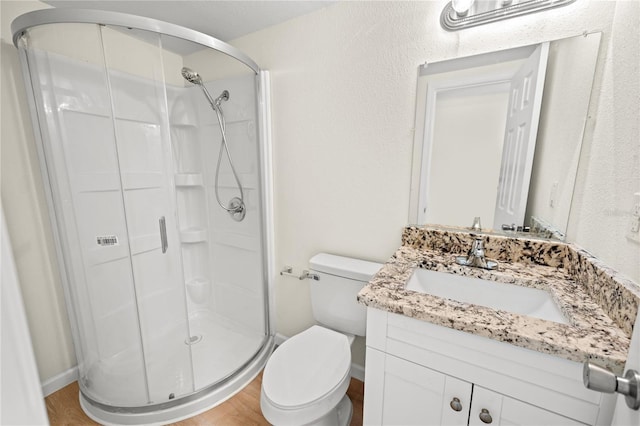 bathroom featuring hardwood / wood-style flooring, vanity, and a shower with shower door