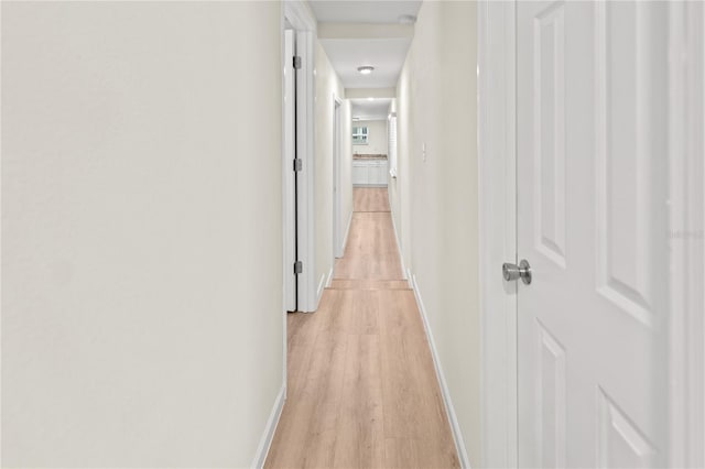 corridor with light hardwood / wood-style flooring