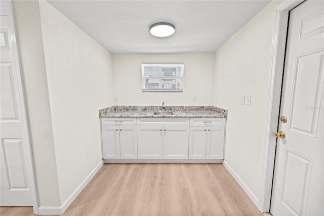 bathroom featuring vanity, hardwood / wood-style flooring, and a textured ceiling