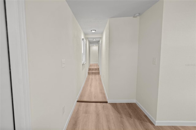 hallway with light hardwood / wood-style flooring