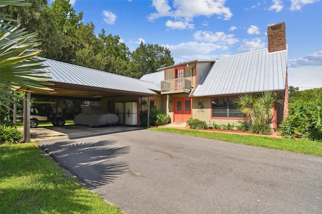 view of front of property with a carport and a balcony