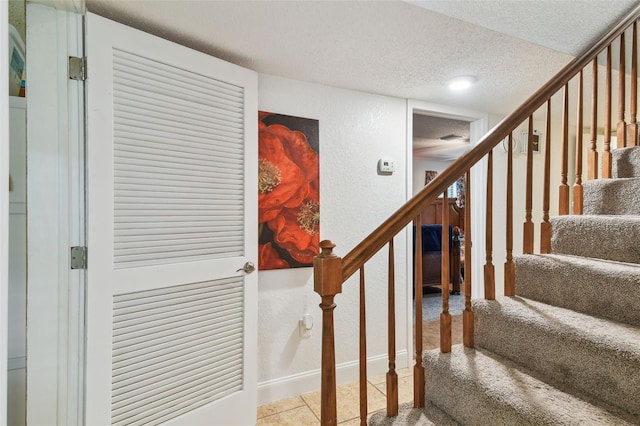 stairway with a textured ceiling