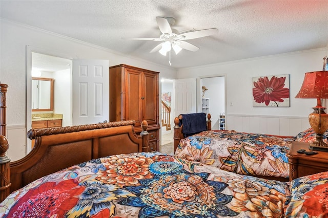 bedroom with a textured ceiling, connected bathroom, crown molding, and ceiling fan