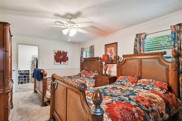 carpeted bedroom with a textured ceiling, ceiling fan, and ornamental molding