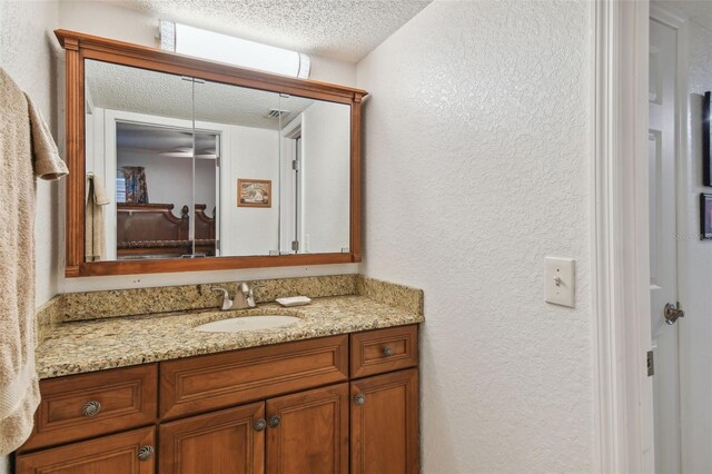 bathroom featuring vanity and a textured ceiling