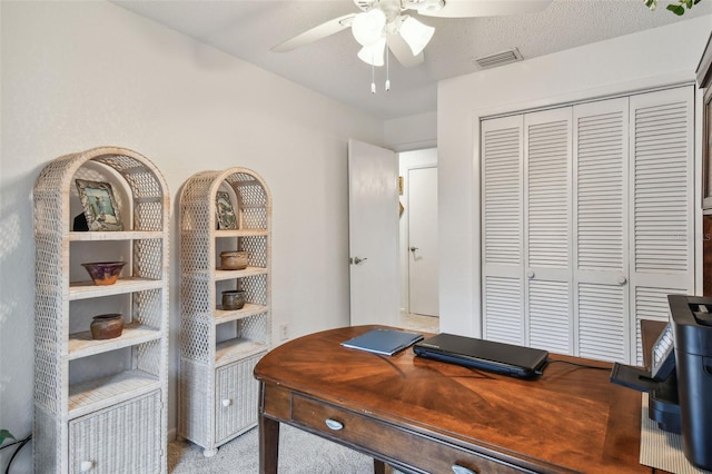 office with light carpet, a textured ceiling, and ceiling fan