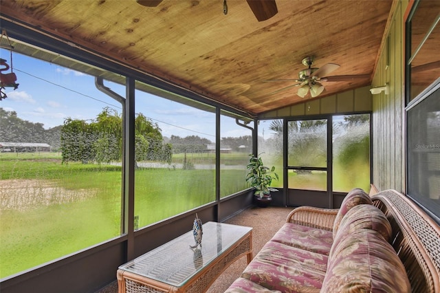 sunroom / solarium featuring ceiling fan, vaulted ceiling, and wooden ceiling