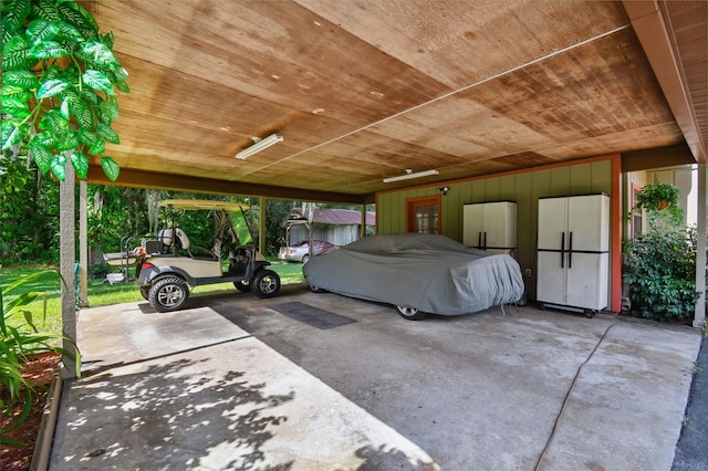 exterior space with white refrigerator, wooden ceiling, and a carport