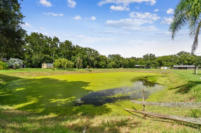 view of community featuring a yard and a water view