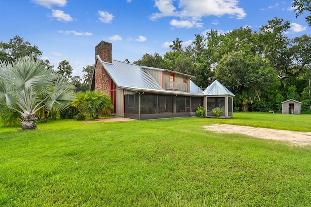 rear view of house with an outdoor structure and a yard