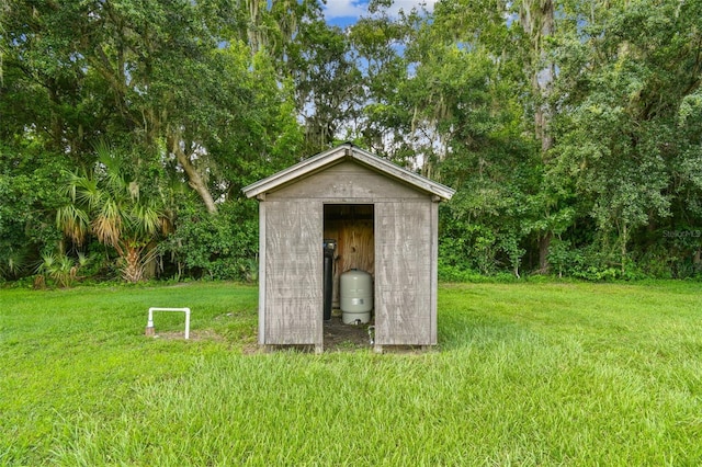 view of outbuilding featuring a lawn