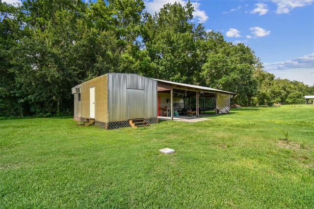 view of outbuilding featuring a yard