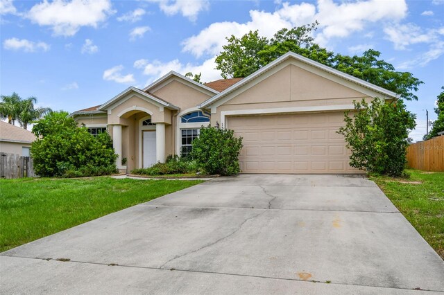 single story home with a garage and a front yard