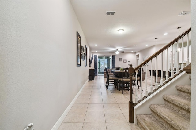 corridor featuring light tile patterned floors