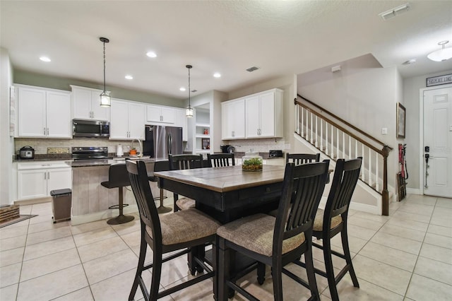 tiled dining space featuring sink