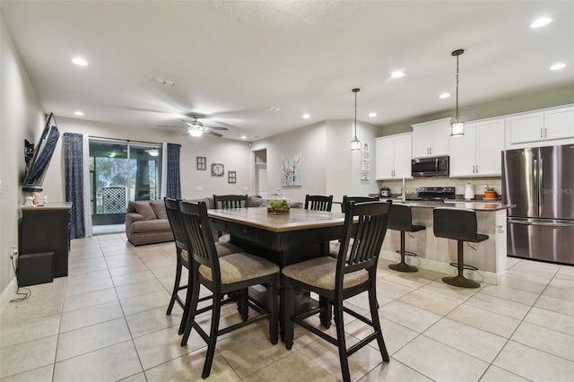 tiled dining room with ceiling fan