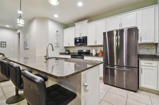 kitchen featuring sink, light tile patterned floors, tasteful backsplash, and stainless steel appliances