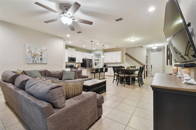 living room with ceiling fan and light tile patterned floors