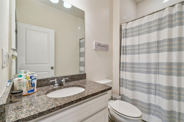 bathroom with toilet and vanity