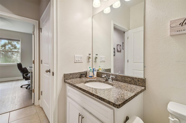 bathroom featuring vanity, toilet, and tile patterned floors