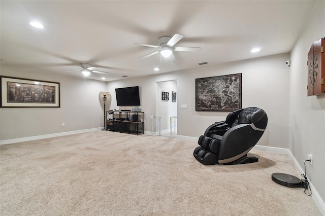 sitting room with ceiling fan and carpet flooring