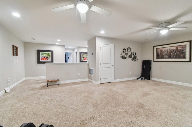 unfurnished living room with light colored carpet and ceiling fan