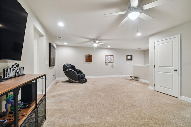 exercise area featuring ceiling fan and light colored carpet