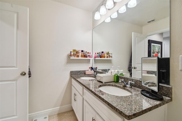 bathroom with tile patterned floors and double sink vanity