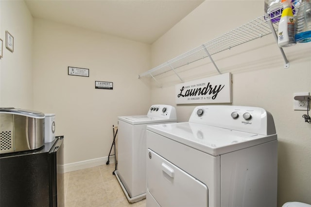 washroom with light tile patterned flooring and washer and clothes dryer