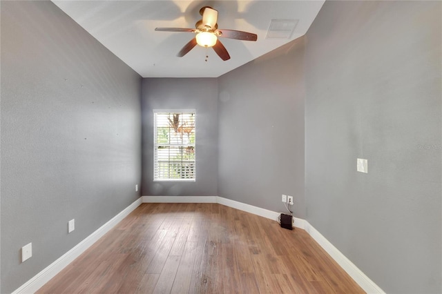 spare room with ceiling fan and light wood-type flooring