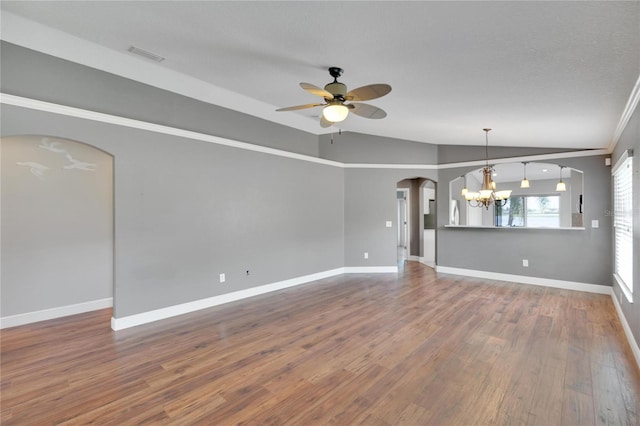 unfurnished living room featuring hardwood / wood-style flooring, ceiling fan with notable chandelier, vaulted ceiling, and a textured ceiling