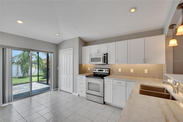 kitchen with hanging light fixtures, sink, white cabinets, and stainless steel electric range