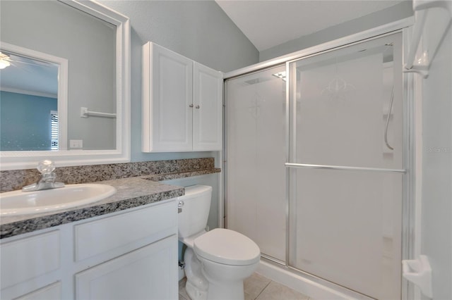 bathroom featuring tile patterned floors, vanity, toilet, and a shower with shower door