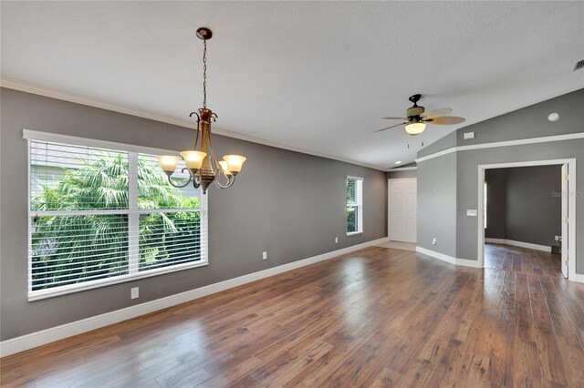 spare room with dark hardwood / wood-style flooring, crown molding, vaulted ceiling, and ceiling fan with notable chandelier