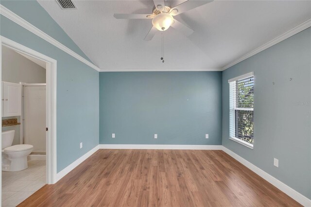 spare room with ceiling fan, lofted ceiling, light hardwood / wood-style flooring, and ornamental molding