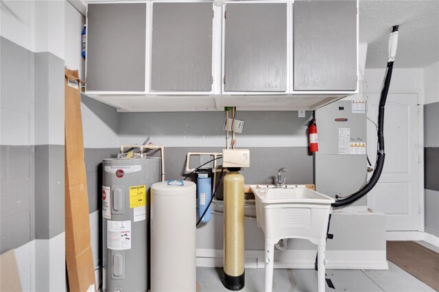 utility room featuring water heater