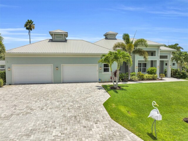 view of front of home featuring a garage and a front lawn