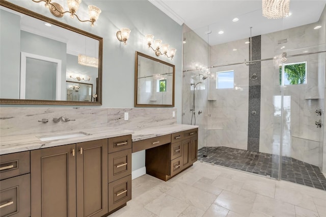 bathroom featuring ornamental molding, tiled shower, vanity, and decorative backsplash