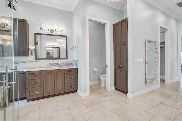 bathroom featuring vanity, ornamental molding, and toilet