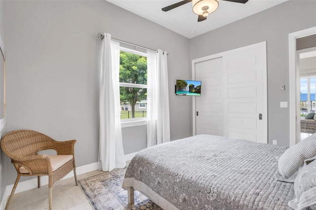 bedroom with ceiling fan and a closet